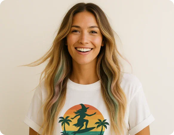 Smiling woman with long wavy hair wearing a white t-shirt with a colorful surfing witch graphic