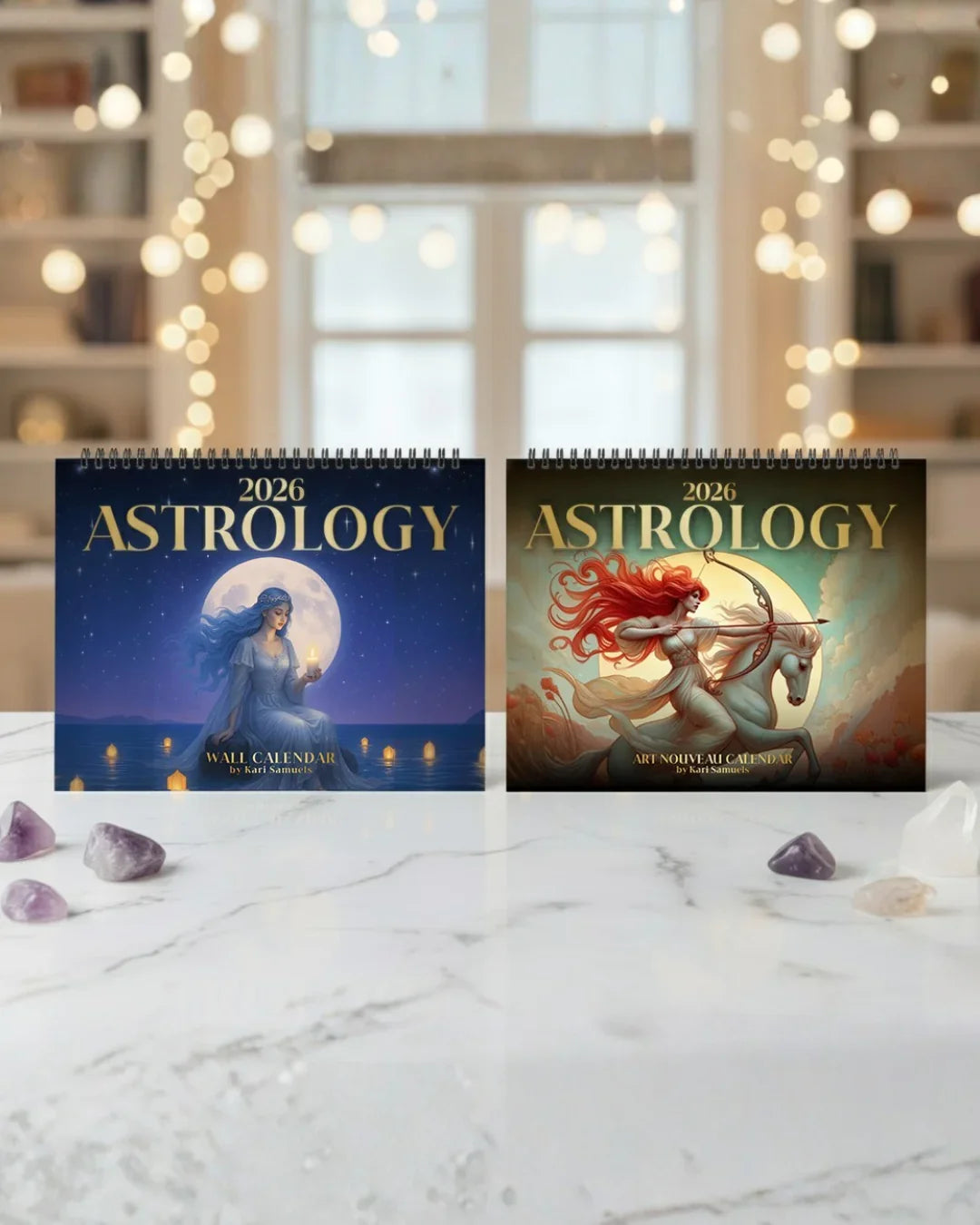 Two 2026 astrology wall calendars by Kari Samuels on marble table with crystals, soft background lights